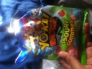 The packaging for the sour candy (held by myself). 